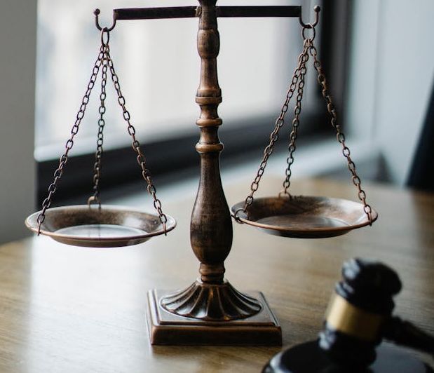 Law scales and gavel on wooden table - symbolizing justice and legal proceedings during the probate process