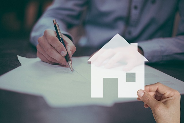 A man signing a contract with a house icon, symbolizing renters insurance in Arkadelphia