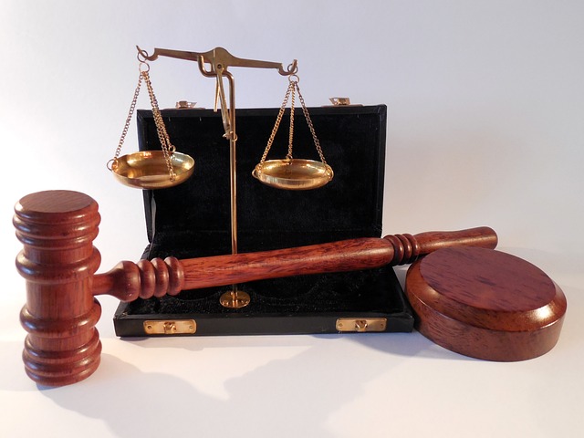 Wooden gavel and scales of justice on white background. Restoration for Felons in Arkansas