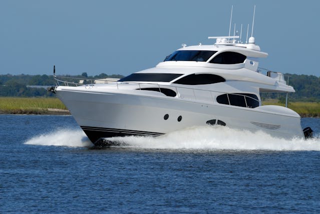 A white motor boat glides on the water. Remember to follow Safety Measures for Boaters. Stay safe on the water! 