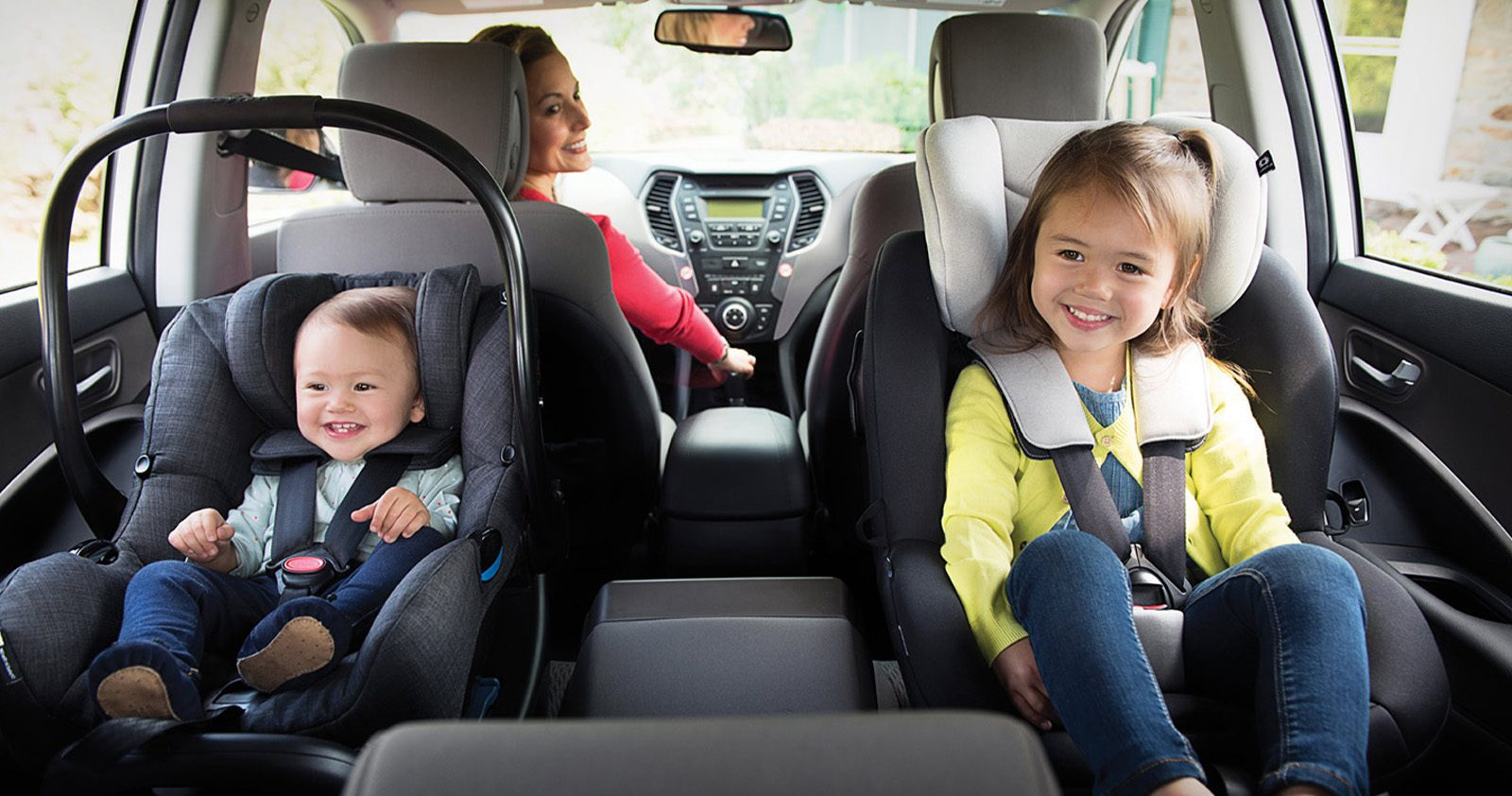 Buckled up children riding in the back seat of a car